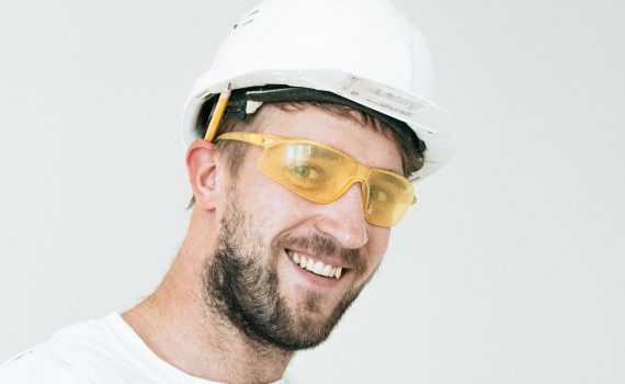 man in white crew neck shirt wearing white cap and black framed eyeglasses